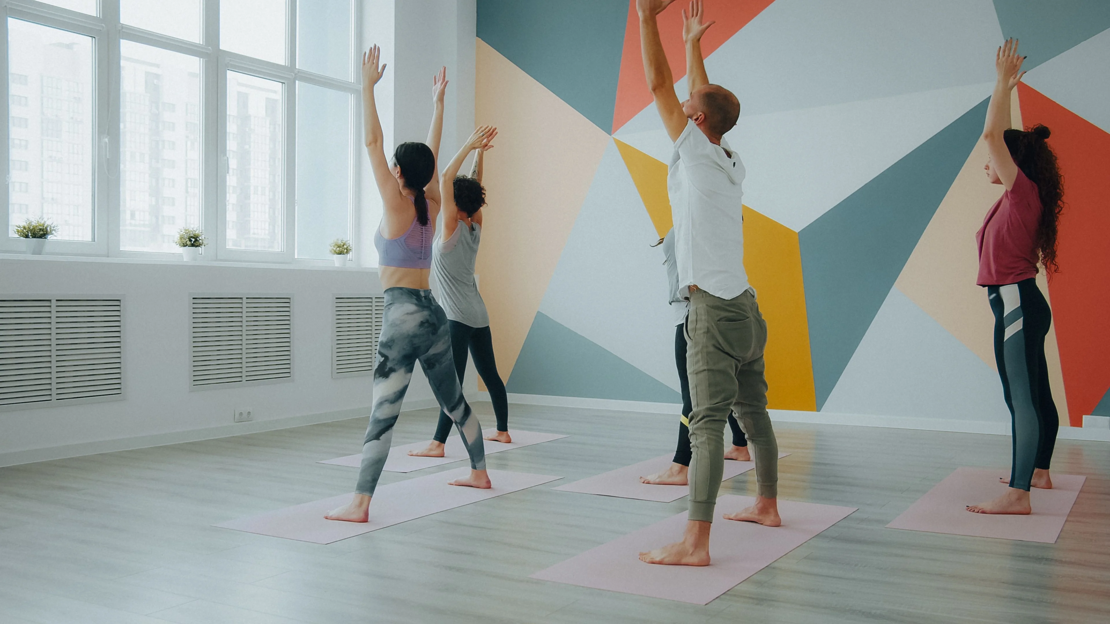 Standing yoga flow in a bright studio